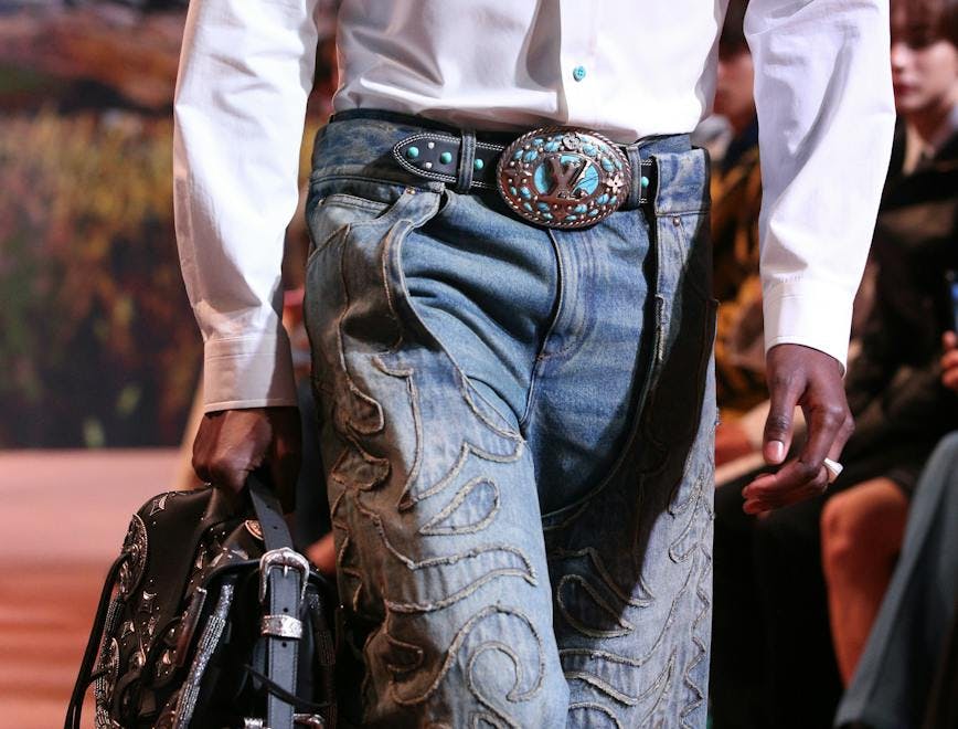 clothing pants jeans baseball glove sport person bag handbag belt long sleeve